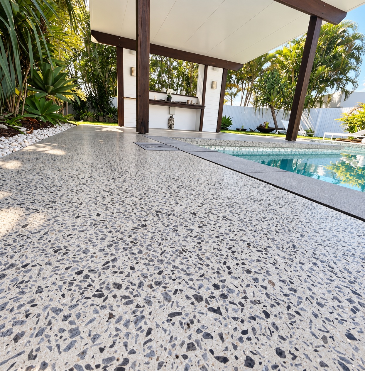Honed concrete pool surround beside a Brisbane outdoor entertaining area